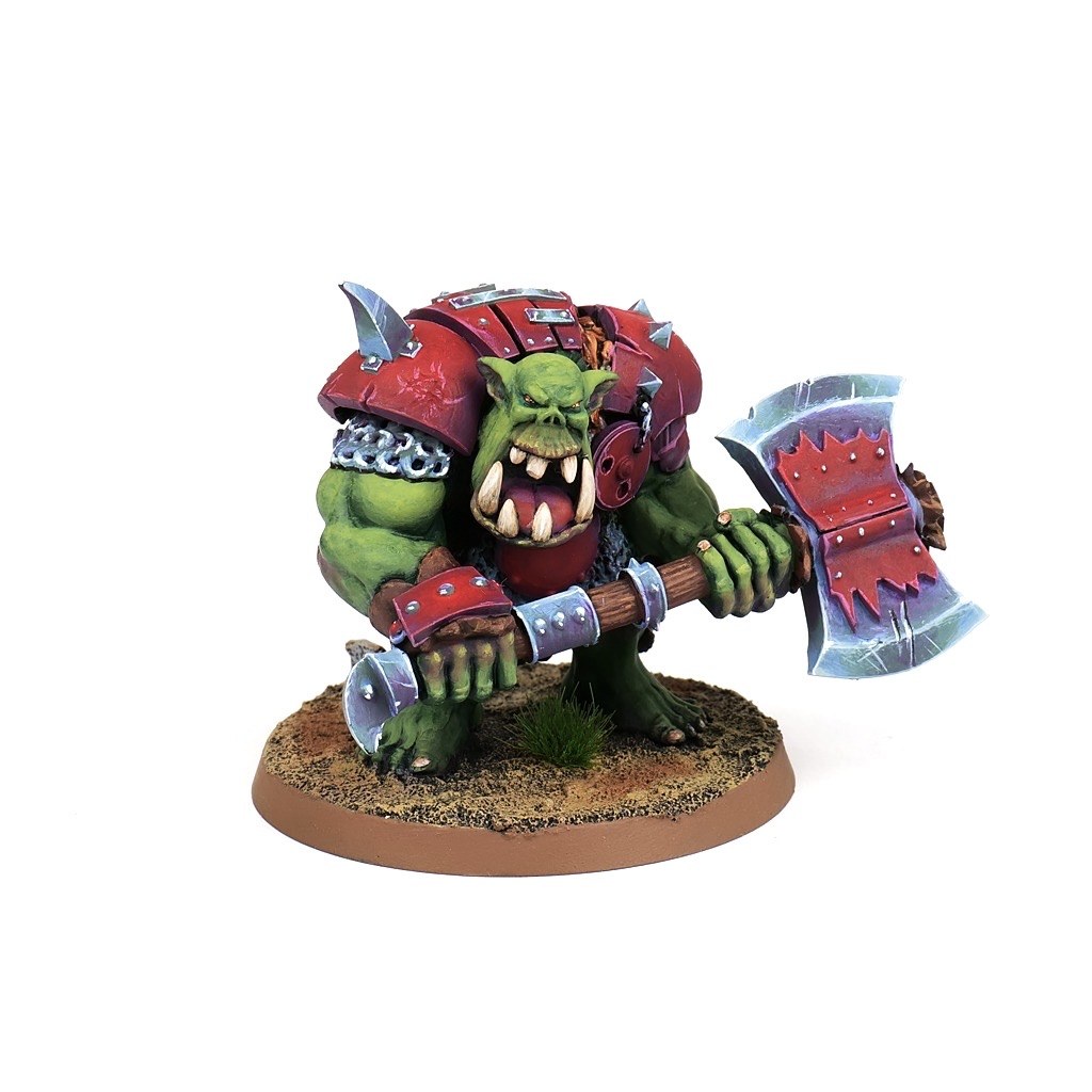 Painted orc boss miniature with a red axe