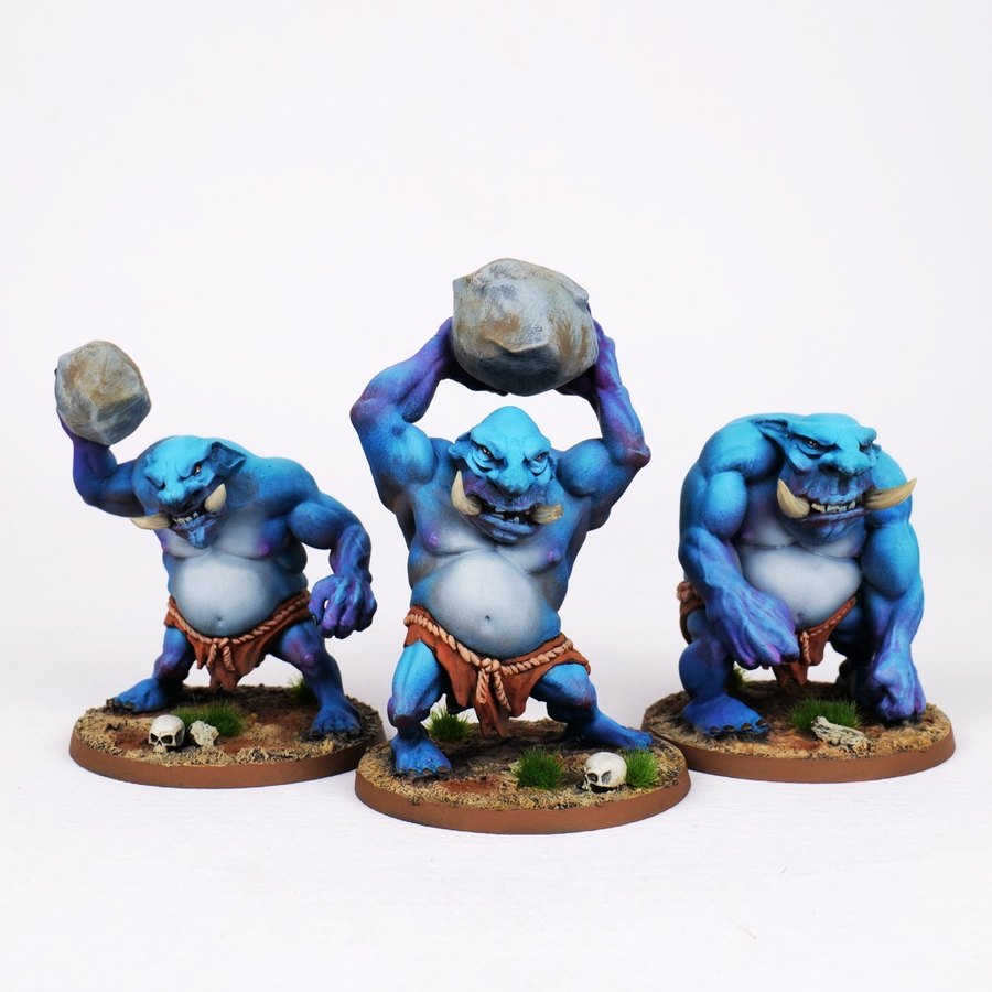 Painted blue troll miniatures with stones