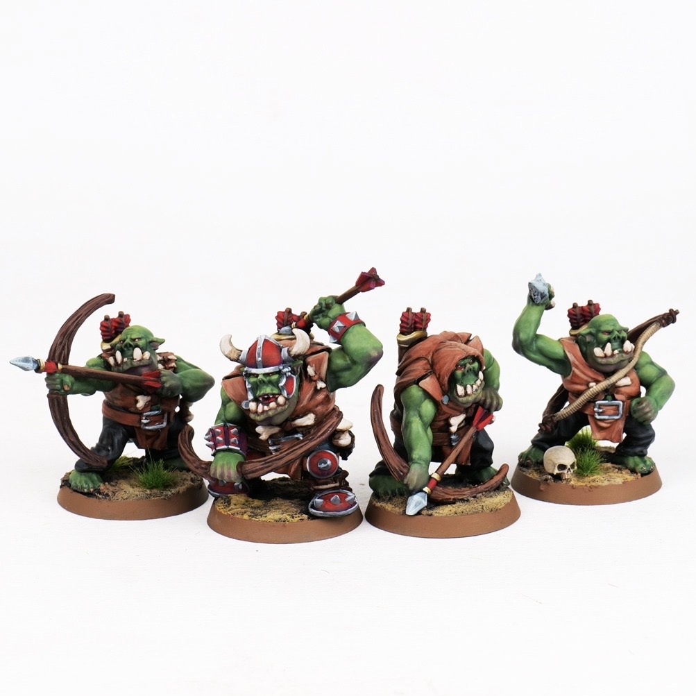 Four painted Orc Archers armed with longbows and daggers