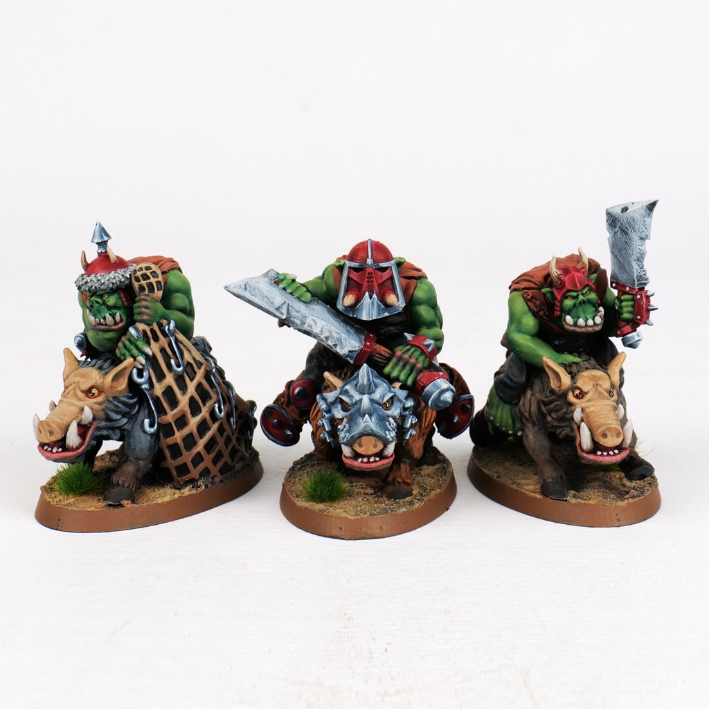 Three painted Orc Boar Riders, including their champion and net carrier