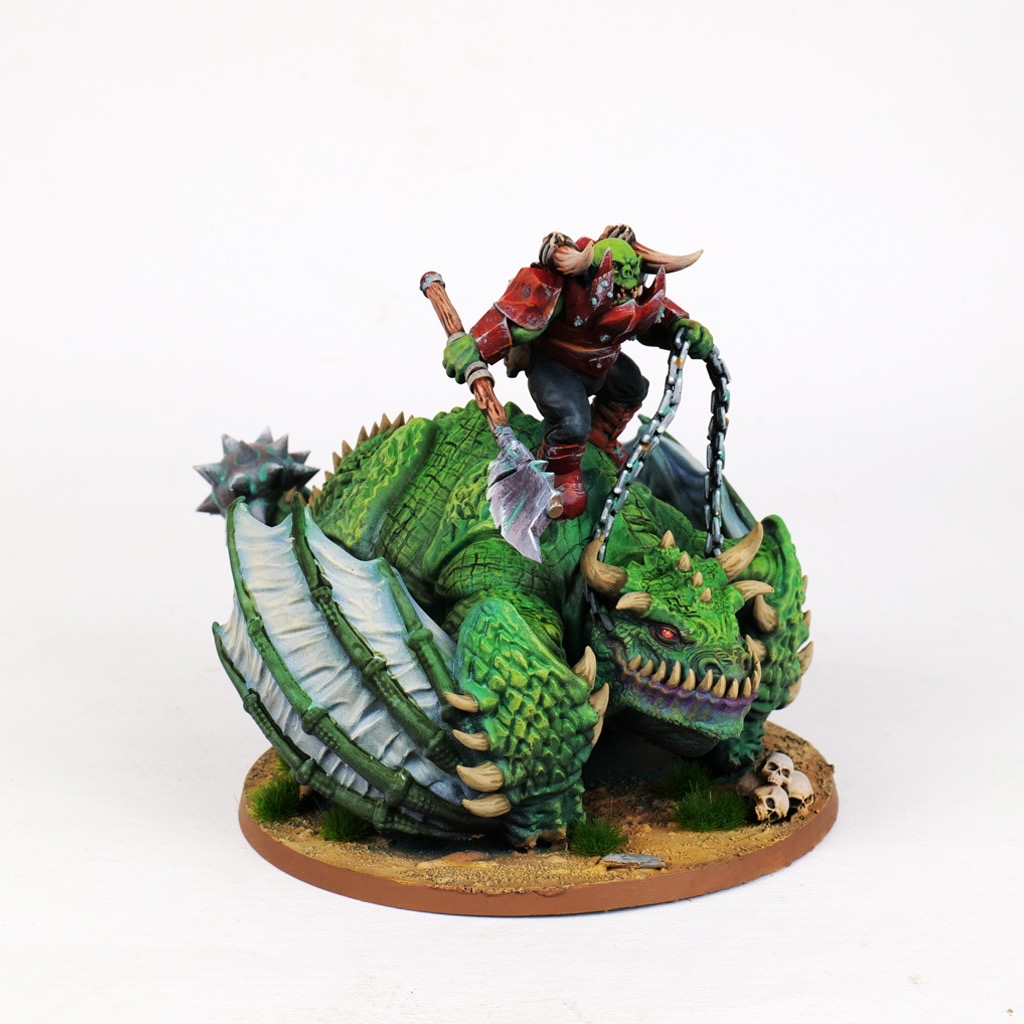 Painted Orc Boss in weathered red armour riding a green Fat Wyvern